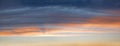 Sky panorama with gray and orange clouds, above blue sky