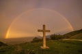 The sky of paradise with wonderful rainbow and cross