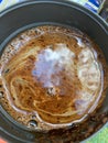 The sky is reflected in a coffee mug. A close up of a bowl.Fancy coffee patterns with foam