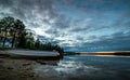 Sky reflection on the blank water surface just before sunset with dark heavy clouds swedish countryside Royalty Free Stock Photo