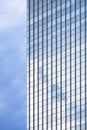 Sky reflection on surface of glass skyscraper against cloudy sky background in vertical frame Royalty Free Stock Photo