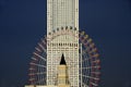 Sky scraper and ferris wheel Royalty Free Stock Photo