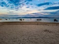 Sky some clouds orange warm lights sand beach boat long tail silent evening water sea islands koh samui asia thailand Royalty Free Stock Photo