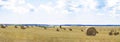 Sky, space, panorama, harvest season, field, clouds, Large round straw bales Royalty Free Stock Photo