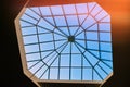 Sky through a square window in the ceiling of the building. Big window in the roof of the hotel Royalty Free Stock Photo