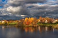 The sky before the storm. Bright autumn dramatic view of the village on the shore of the lake before a thunderstorm Royalty Free Stock Photo