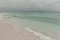Sky with storm clouds over a calm sea. Maldives, a beach with the white sand near the turquoise ocean. Royalty Free Stock Photo