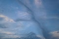 Sky with strange formations of a streak of dark clouds stretching vertically from bottom to top Royalty Free Stock Photo