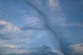 Sky with strange formations of a streak of dark clouds stretching vertically from bottom to top