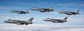 Sky Symphony: Five Stealth Fighter Jets in Precision Formation Royalty Free Stock Photo