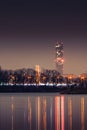 Sky Tower Wroclaw and the Milenijny Bridge over the Odra River visible in the evening from the shore Royalty Free Stock Photo