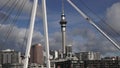 Sky tower with Wynyard Crossing at Auckland Viaduct Harbor Basin