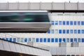 Sky-Train passing fast in front of office building