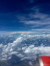 Sky view from airplane window. There were clusters of clouds in the blue sky and the appearance of the engine of the aircraft Royalty Free Stock Photo