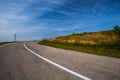 Sky with white clouds over empty asphalt road during summer Royalty Free Stock Photo