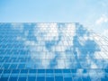 The sky with white clouds reflecting in the glass windows of a modern office building Royalty Free Stock Photo