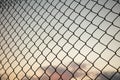 Sky through wire mesh fence. Blur background, close up view of link cage. Royalty Free Stock Photo