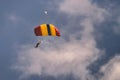 Multicolored parachute in blue sky