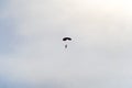 Skydiver with blue little canopy of a parachute on the background a blue sky and white clouds Royalty Free Stock Photo