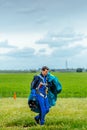 Skydiver carries a parachute after landing