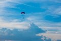 Skydiver on colorful parasailing in blue sky over the sea Royalty Free Stock Photo