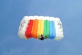 Parachuter, skydiver jumping and skydiving with colorful parachute in rainbow colours on parachuting cup, extreme sport