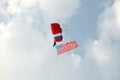 A skydiver carrying an American flag.