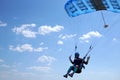 Skydiver flies with the little blue parachute, quickly approaching, close-up Royalty Free Stock Photo