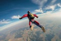 Skydiver in freefall over rural landscape. Aerial view with clear blue sky Royalty Free Stock Photo