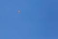 Skydiver with a little canopy of a parachute on the background a blue sky, close-up. Skydiver under parachute Royalty Free Stock Photo