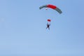 Skydiver with a little canopy of a parachute on the background a blue sky, close-up. Skydiver under parachute Royalty Free Stock Photo