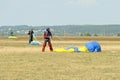 Skydiver unfasten his parachute after landing Royalty Free Stock Photo