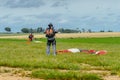 Skydiver unfasten his parachute after landing. Royalty Free Stock Photo