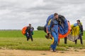 Skydivers carries a parachute after landing.