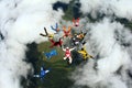Skydivers are doing a formation in the clouds. Royalty Free Stock Photo