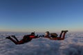 Skydiving. Two skydivers are flying in the sunset sky. Royalty Free Stock Photo