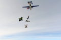 Formation skydiving. Skydivers are jumping out of an airplane into the sky.