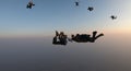 Silhouette of a group of skydivers jumping at the end of the day. Royalty Free Stock Photo