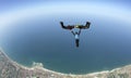 Skydiving 3D formation having fun over sea