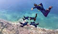Skydiving formation with videoman over sea Royalty Free Stock Photo