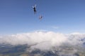 Skydiving. Freefly jump above white clouds. Royalty Free Stock Photo