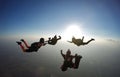 Skydiving group silhouette at the sunset.