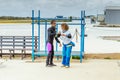 Skydiving instructor teaches her the correct skydiving position before jumping.