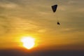 Skydiving sunset landscape of parachutist flying in soft focus. Para-motor flying silhouette with sun set.