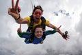 Skydiving tandem having fun on a cloudy day. Royalty Free Stock Photo