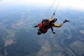 Skydiving. Tandem jump. Man and young woman are falling in the sky together. Royalty Free Stock Photo