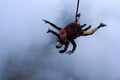 Skydiving. Tandem jump. Man and young woman are falling in the sky together. Royalty Free Stock Photo