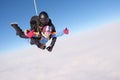 Skydiving. Tandem jump. Two skydivers are in the sky.