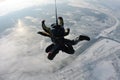 Skydiving tandem jumping from the plane against the background of the earth