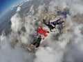 Skydiving 4 way team above the clouds. Royalty Free Stock Photo